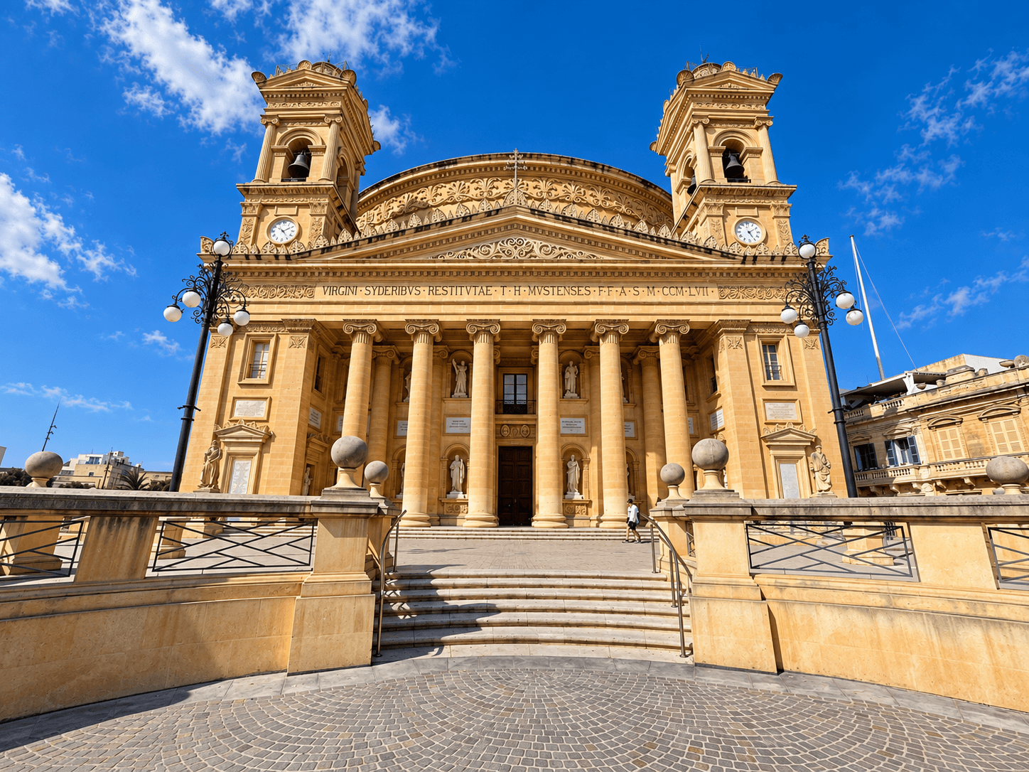 Front view of Mosta Rotunda with twin bell towers and steps leading to the entrance